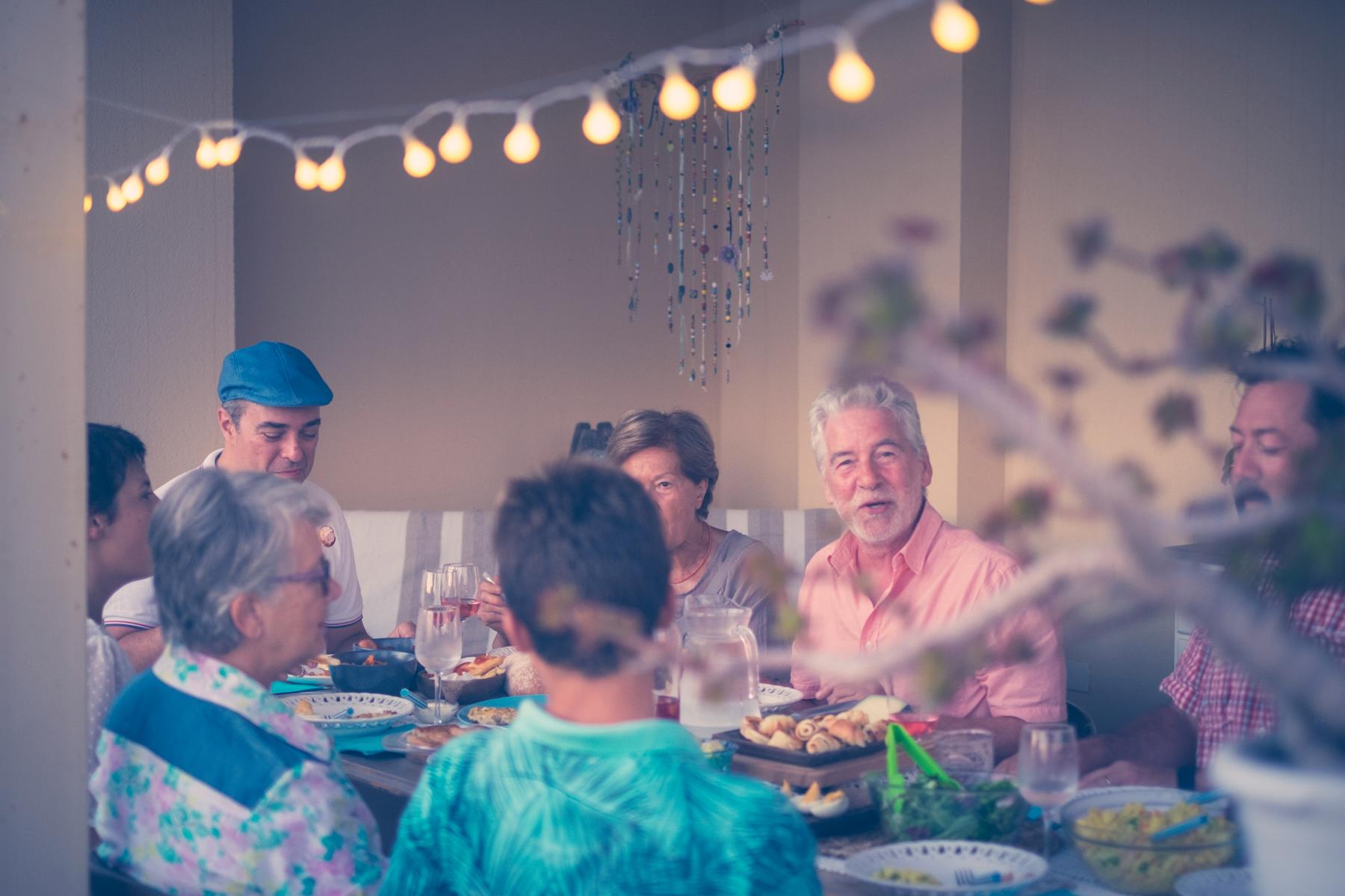 family having a dinner party different ages