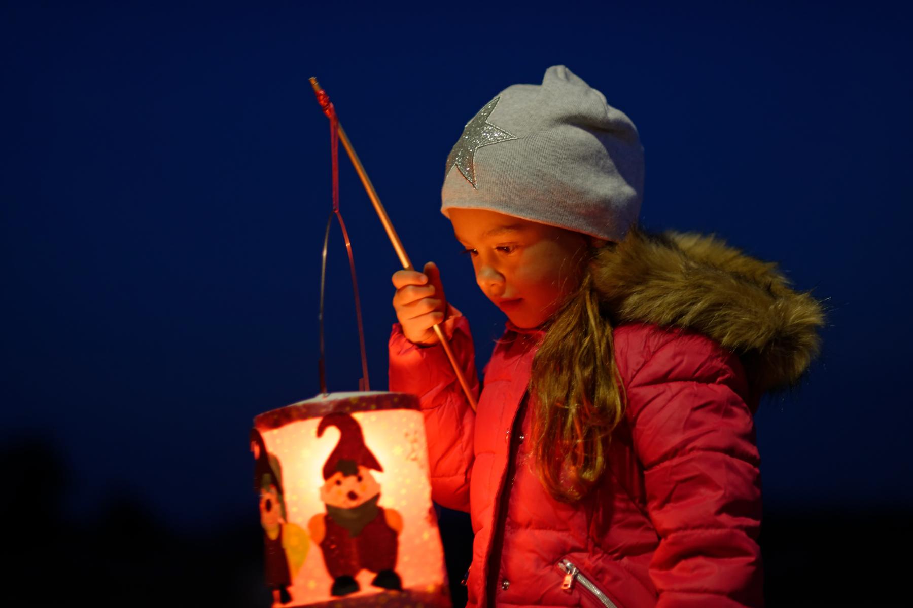 Portrait of little girl with lighted paper lantern